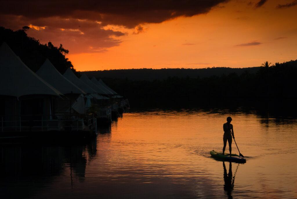 Astro Travel in Cambodia - a man on a SUP at sunset