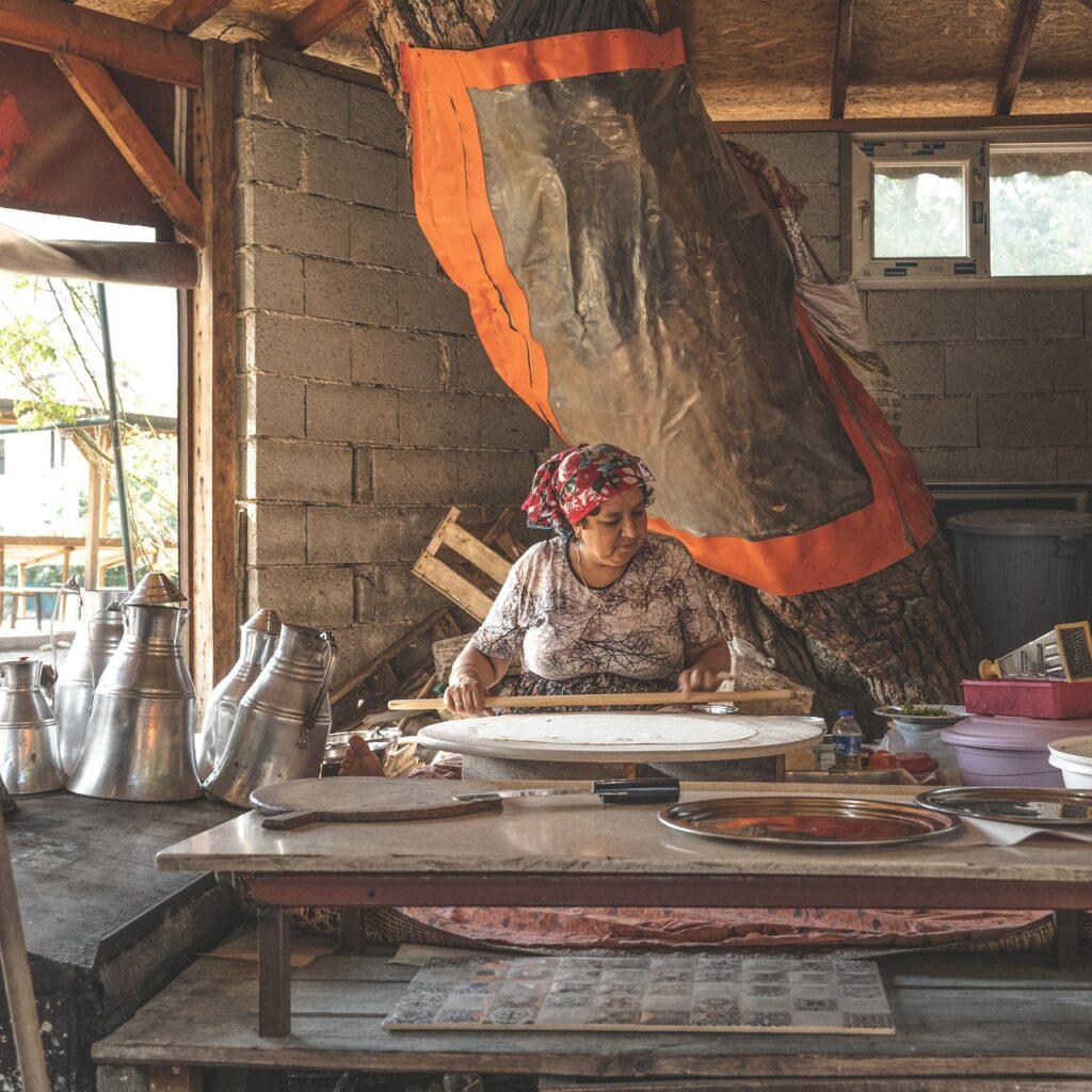 A woman rolls out dough in a Turkish workshop