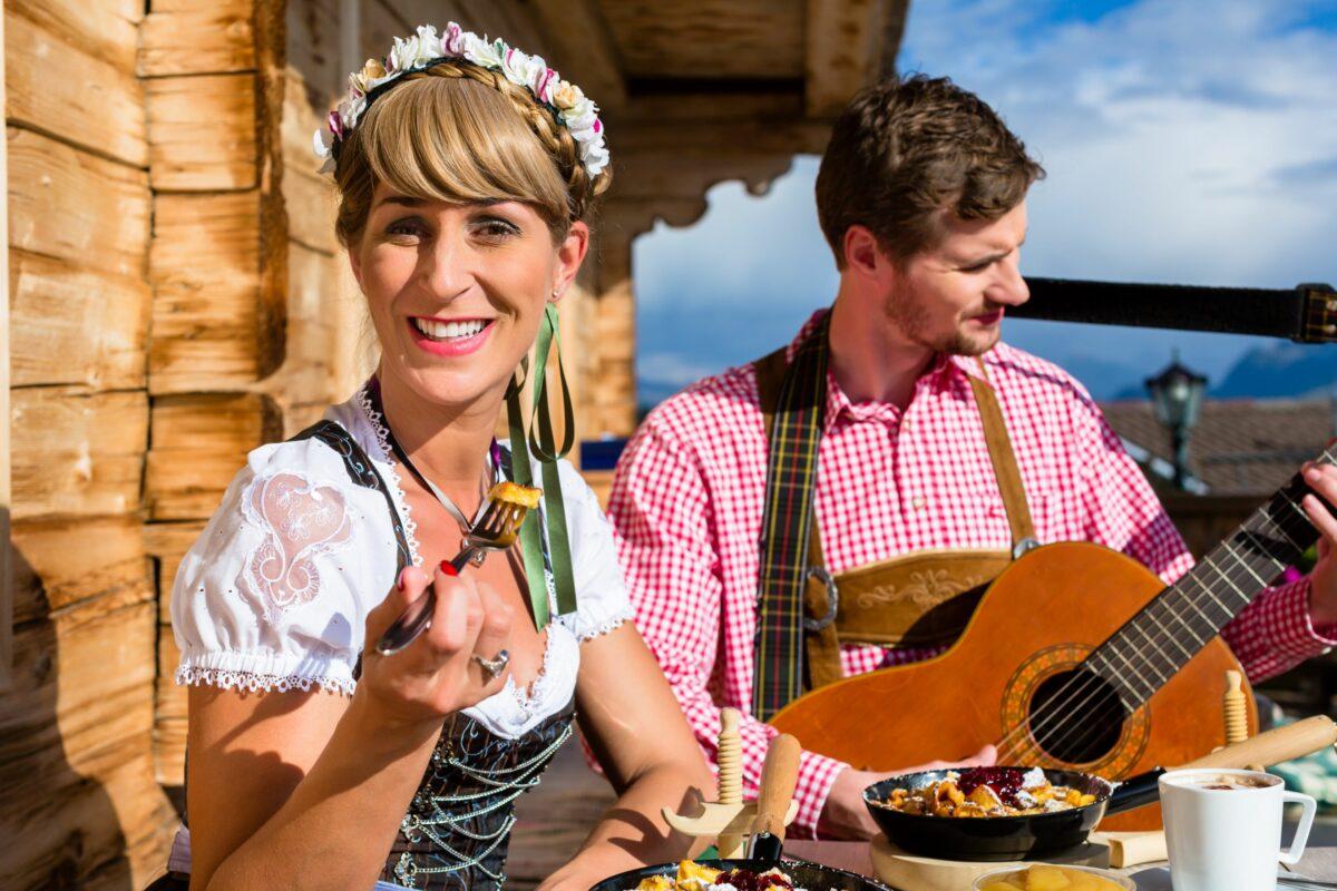 Culinary delights in the Allgäu - a couple in traditional costumes in a mountain hut