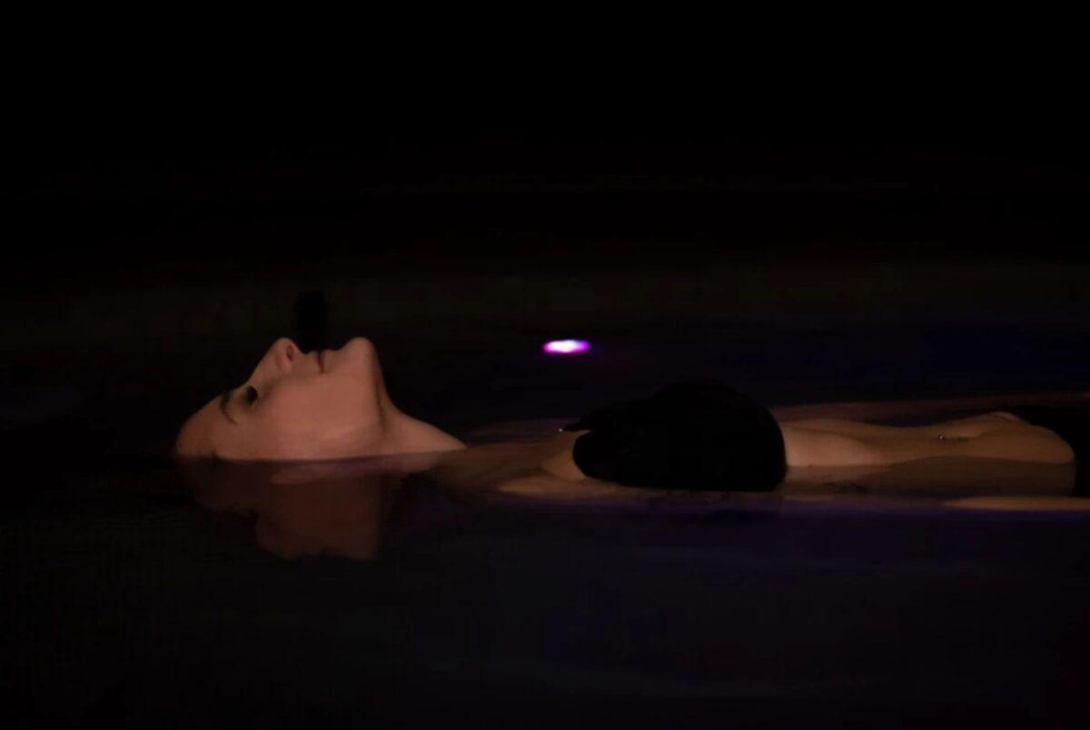 Floating in a sustainable hotel with saltwater - Woman floating in water
