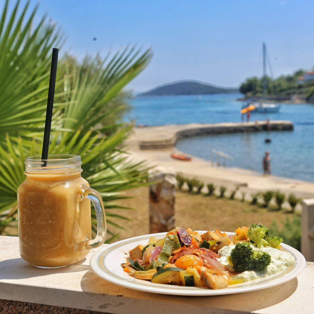 Healthy vegan food with fresh juice in the sunshine by the sea in Croatia