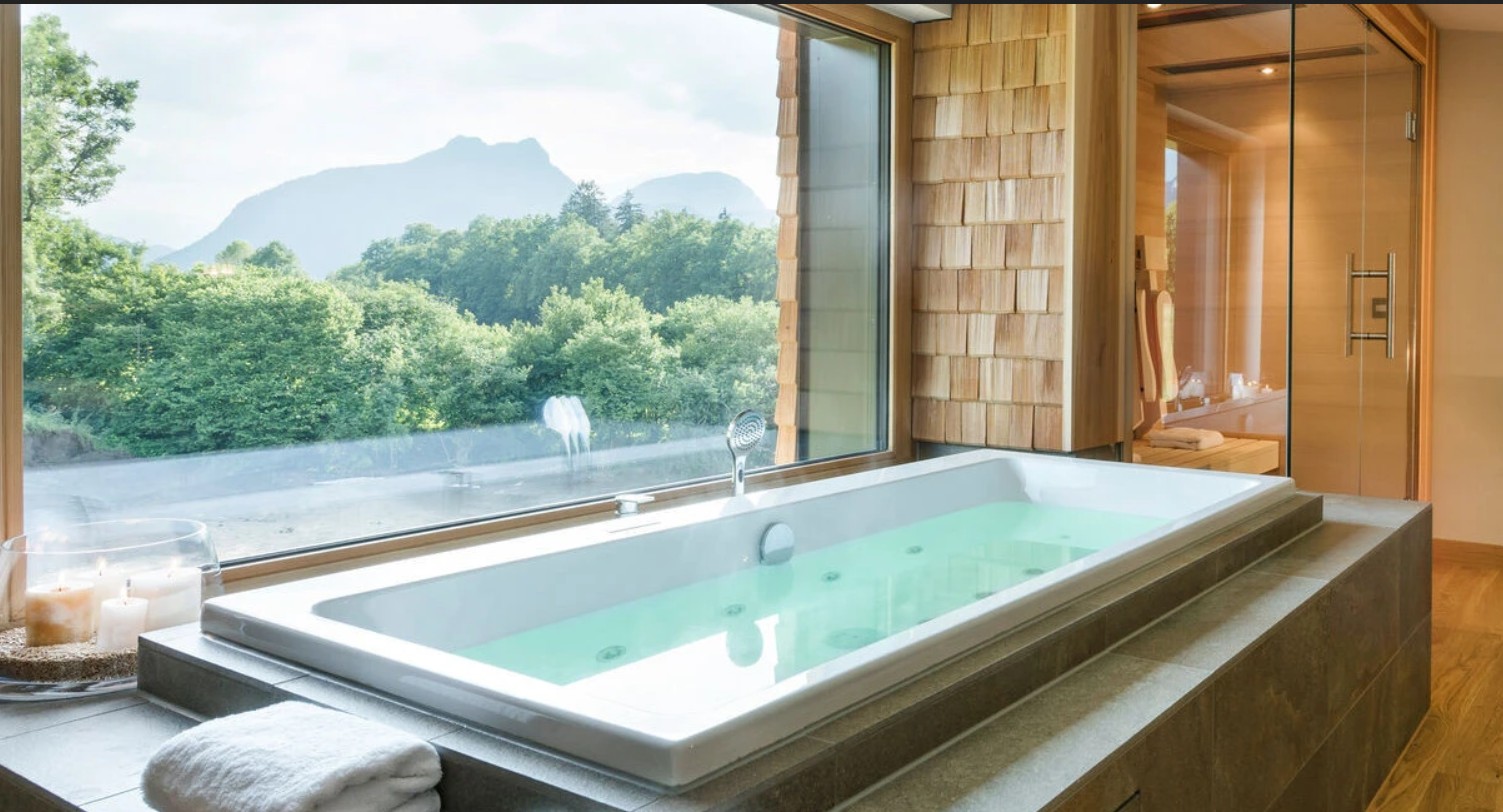 Spa loft hotel room with a private sauna and whirlpool tub offering a panoramic view