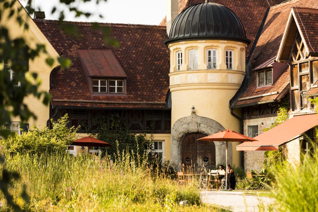 Sustainable Hotel in Germany near Munich - outside view - nice weather people 