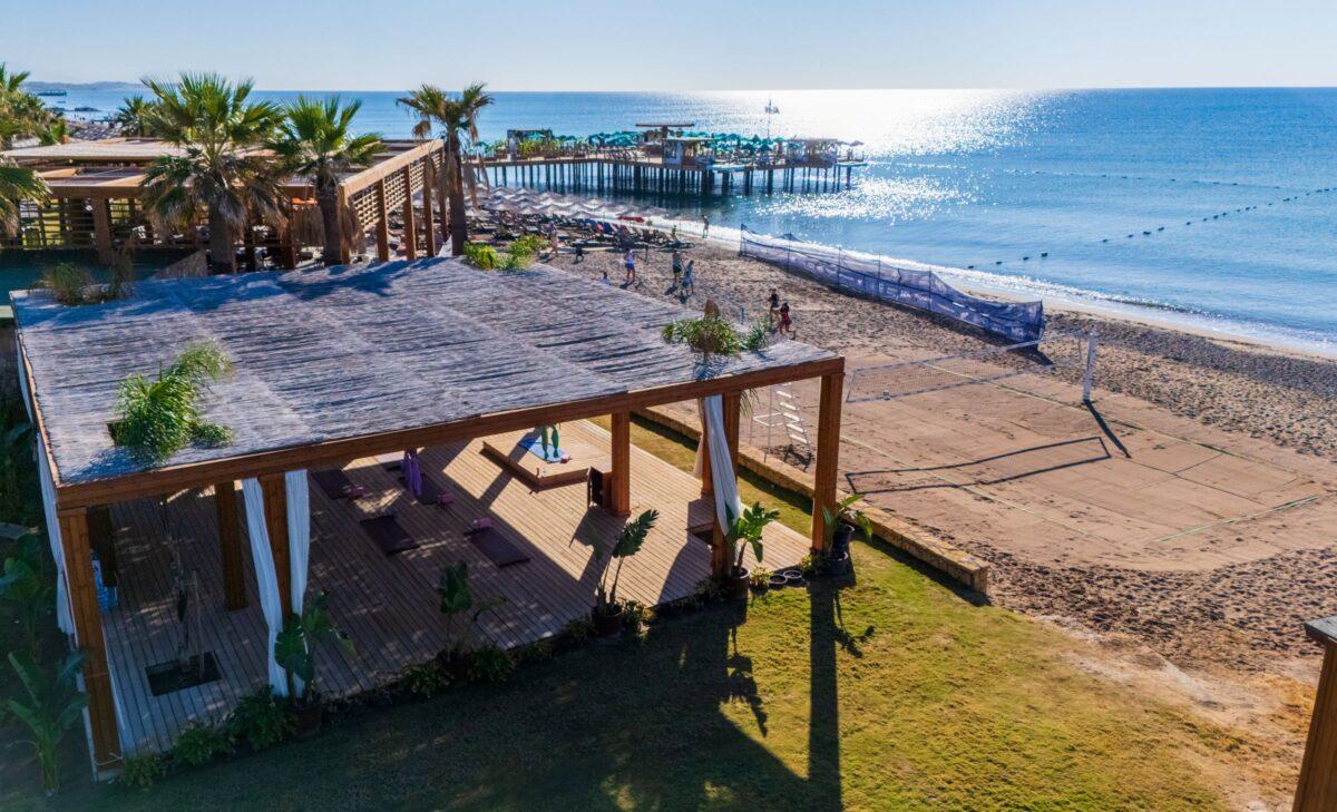 Drone footage of beach yoga
