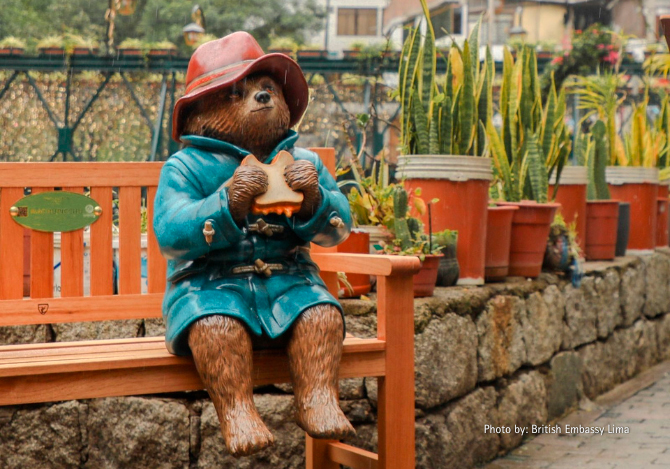 The Paddington statue sitting on a bench at the Inkaterra Hotel in Peru