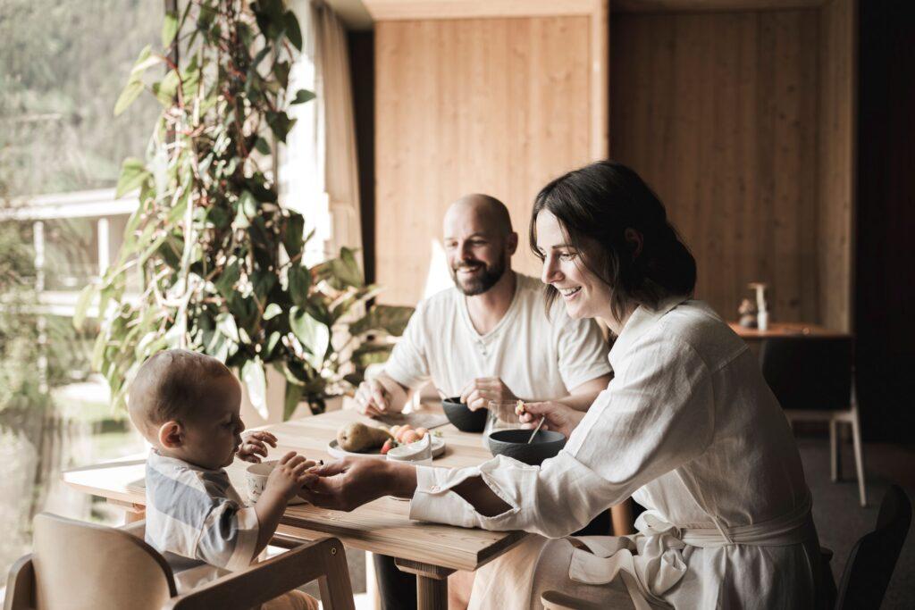 A family sits at the breakfast table in the Prenn Restaurant at OLM Nature Escape.