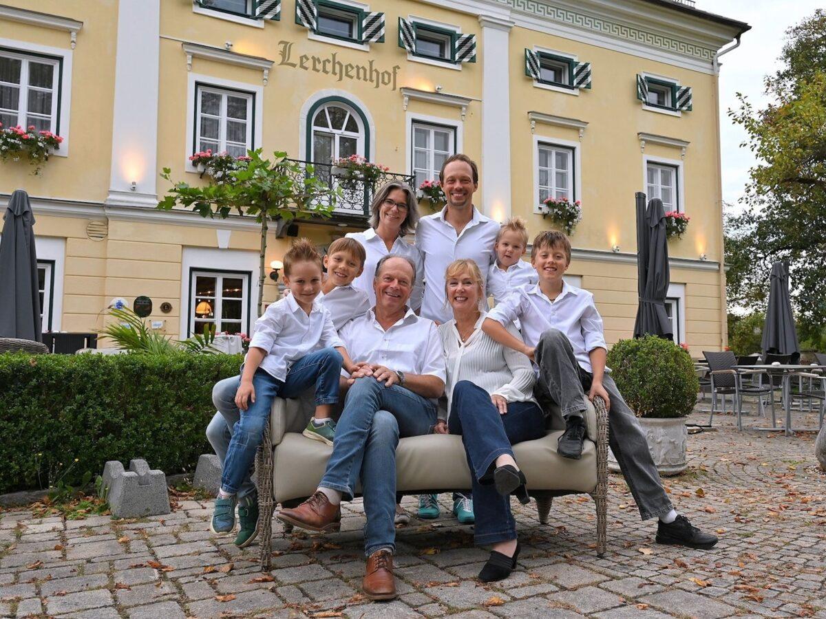 The three generations of the Steinwender family stand in front of the eco-friendly Lerchenhof Castle.