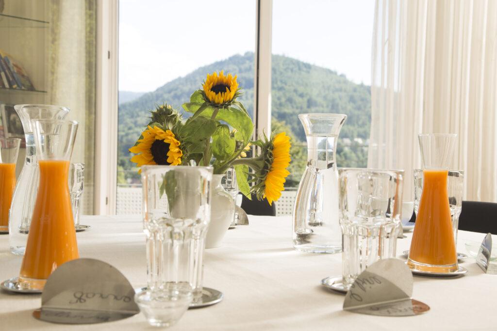 You see a table set for a fasting cure. Glasses and carafes of water and juice are ready and waiting.