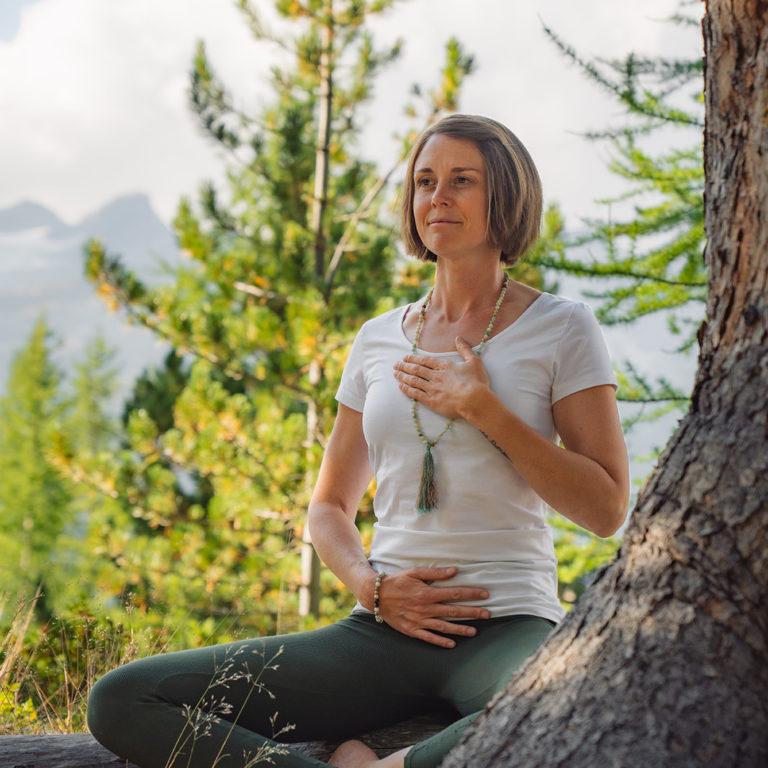 Breathwork instructor Stefanie leading breathing exercises in the forest in Zermatt