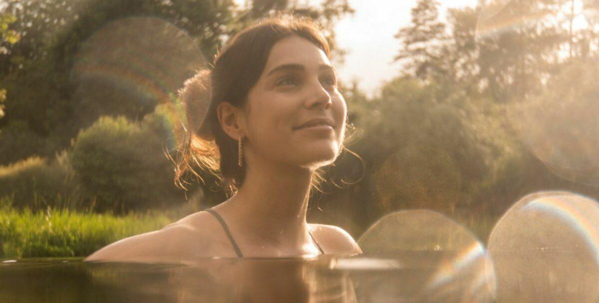 Woman swimming in a natural swimming pond of Hotel STURM filled with Grander Water