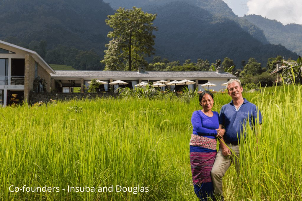 Married couple Insuba and Douglas Maclagan in front of their eco-luxury resort in Nepal
