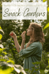 A woman with shoulder-length hair and a green shirt is standing in a garden, holding a red fruit in her hand