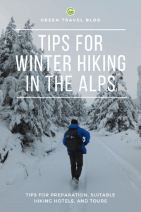 Person with backpack hiking on snowy trail through winter coniferous forest, surrounded by sustainable hiking hotels.